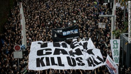 Protesters display a large banner during a rally to support press freedom in Hong Kong on March 2, 2014. The rally was staged following the attack of a former editor of local liberal newspaper which comes at a time of growing unease over freedom of the press in the southern Chinese city, with mounting concerns that Beijing is seeking to tighten control over the semi-autonomous region.  AFP PHOTO / Philippe Lopez        (Photo credit should read PHILIPPE LOPEZ/AFP/Getty Images)