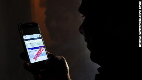 A Sri Lankan man mobile phone user shows an image on Twitter showing that the Facebook site had been blocked in Colombo on March 7, 2018. - Telecommunication service providers said they have blocked access to facebook and several other social media platforms on the directive of the government which accused extremists of using the popular social media to spread hate speech and instigate violence against the Muslim minority in the country. (Photo by ISHARA S. KODIKARA / AFP)        (Photo credit should read ISHARA S. KODIKARA/AFP/Getty Images)