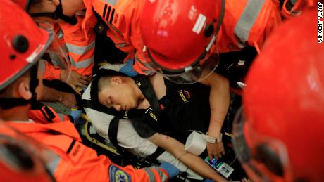 Medical staffs carry a detained man, who protesters claimed was a police officer from mainland China, during a demonstration at the Airport in Hong Kong, Tuesday, Aug. 13, 2019. Riot police clashed with pro-democracy protesters at Hong Kong&#39;s airport late Tuesday night, a chaotic end to a second day of demonstrations that caused mass flight cancellations at the Chinese city&#39;s busy transport hub. (AP Photo/Vincent Yu)