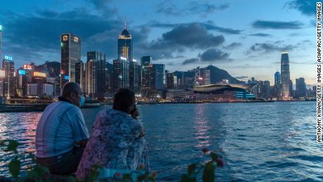 HONG KONG, CHINA - JULY 30: A couple enjoy their moment at a typhoon shelter during sunset in front of Hong Kong skyline on July 30, 2020 in Hong Kong, China. Hong Kong have recorded the highest daily tally of Covid-19 with 149 confirmed cases. (Photo by Anthony Kwan/Getty Images)