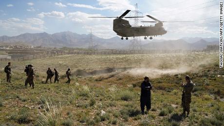 In this photo taken on June 6, 2019, a US military Chinook helicopter lands on a field outside the governor&#39;s palace during a visit by the commander of US and NATO forces in Afghanistan, General Scott Miller, and Asadullah Khalid, acting minister of defense of Afghanistan, in Maidan Shar, capital of Wardak province. - A skinny tangle of razor wire snakes across the entrance to the Afghan army checkpoint, the only obvious barrier separating the soldiers inside from any Taliban fighters that might be nearby. (Photo by THOMAS WATKINS / AFP) / To go with &#39;AFGHANISTAN-CONFLICT-MILITARY-US,FOCUS&#39; by Thomas WATKINS        (Photo credit should read THOMAS WATKINS/AFP via Getty Images)