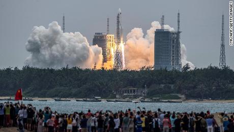 TOPSHOT - People watch a Long March 5B rocket, carrying China&#39;s Tianhe space station core module, as it lifts off from the Wenchang Space Launch Center in southern China&#39;s Hainan province on April 29, 2021. - China OUT (Photo by STR / AFP) / China OUT (Photo by STR/AFP via Getty Images)