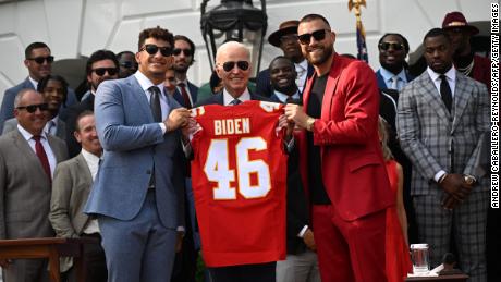 Kansas City Chiefs tight end Travis Kelce and quarterback Patrick Mahomes present US President Joe Biden with a jersey during a celebration for the Kansas City Chiefs, 2023 Super Bowl champions, on the South Lawn of the White House in Washington, DC, on June 5.