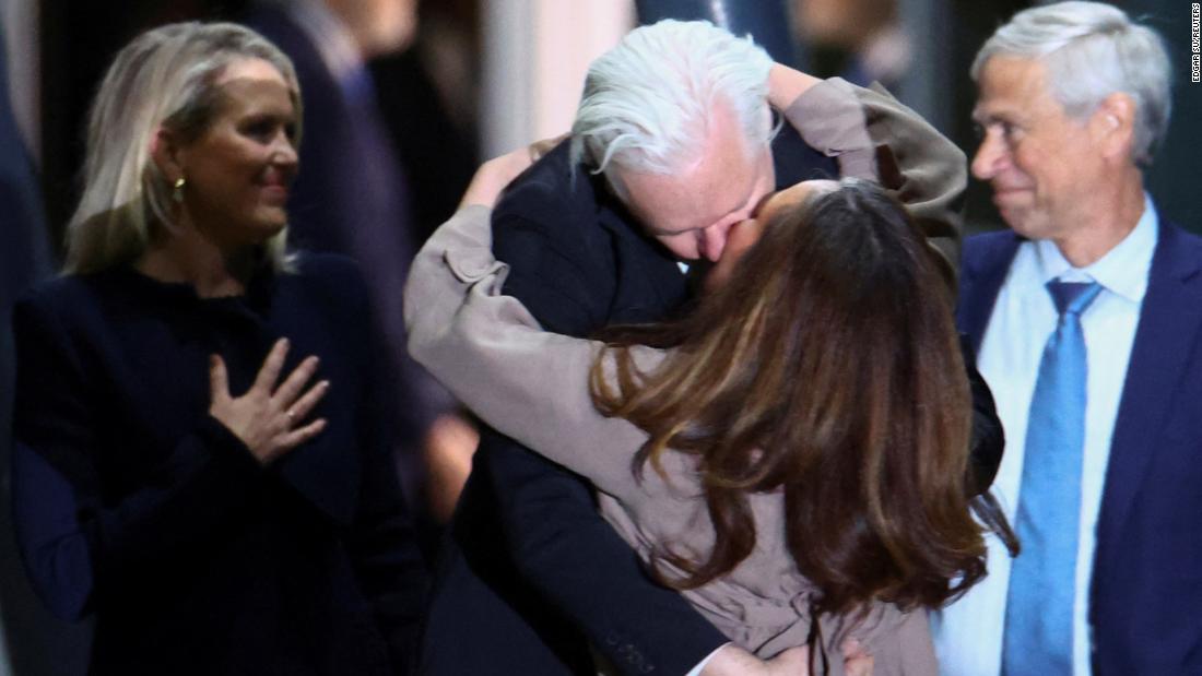 Assange kisses his wife Stella Assange as he arrives in Canberra on June 26.