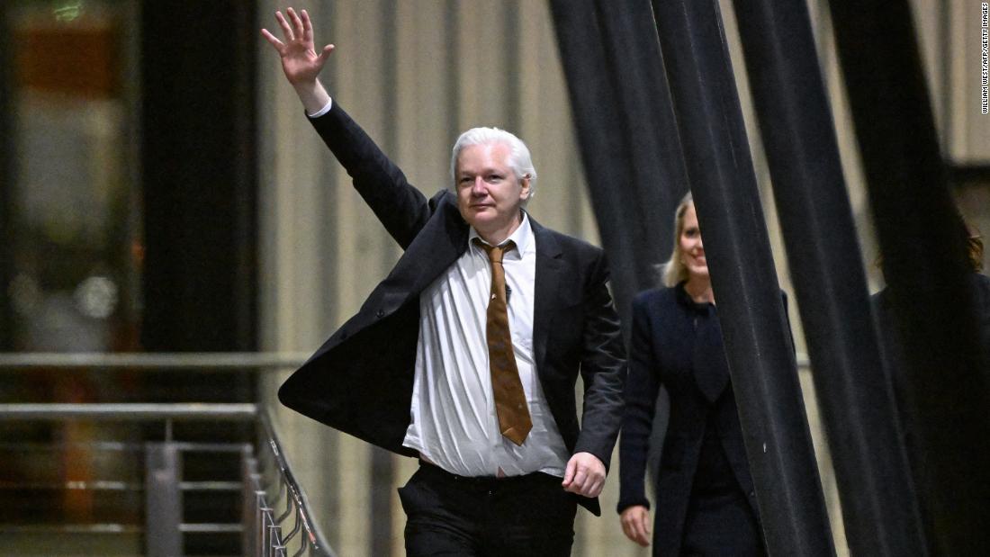 WikiLeaks founder Julian Assange waves after arriving at Canberra Airport in Canberra, Australia, on June 26.