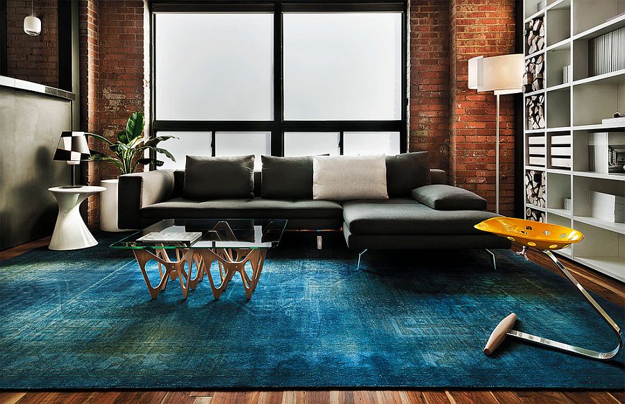 Contemporary living space with rug in copper blue and plush sofa in dark gray [From: James Maynard- Vantage Imagery]