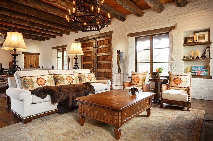 Heavy wooden beams and brick walls accentuate the Southwestern style in the room [Design: Chandler Prewitt Interior Design]