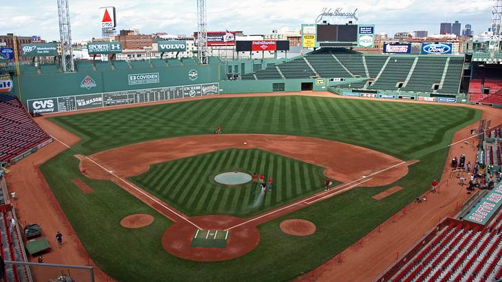 Baseball stadium with a big green wall on the left of the field