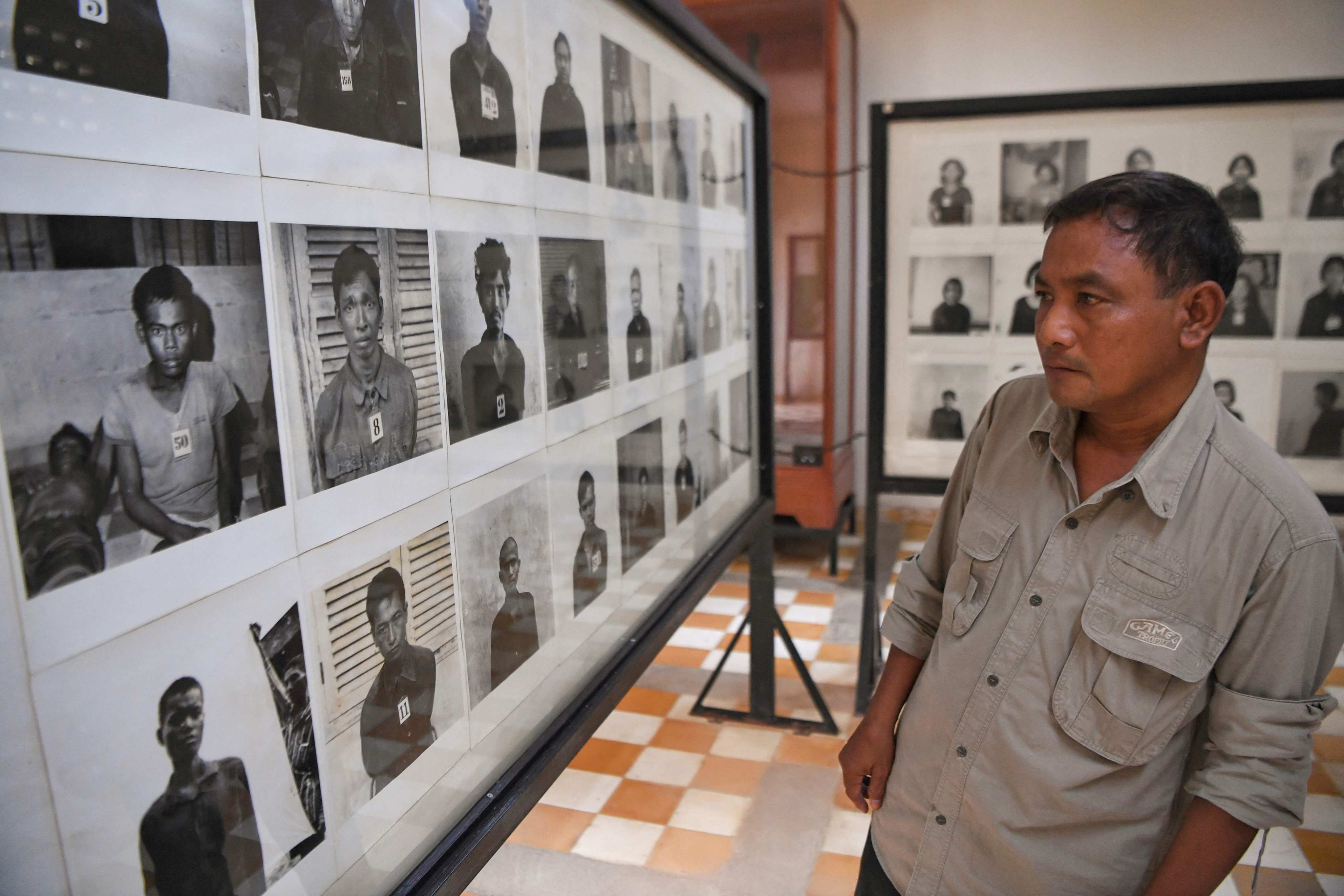 A man looks at portraits of victims displayed at the Tuol Sleng Genocide Museum, formerly a prison where thousands of Cambodians died during the brutal 1975-79 regime, in Phnom Penh, in 2020. Photo: AFP