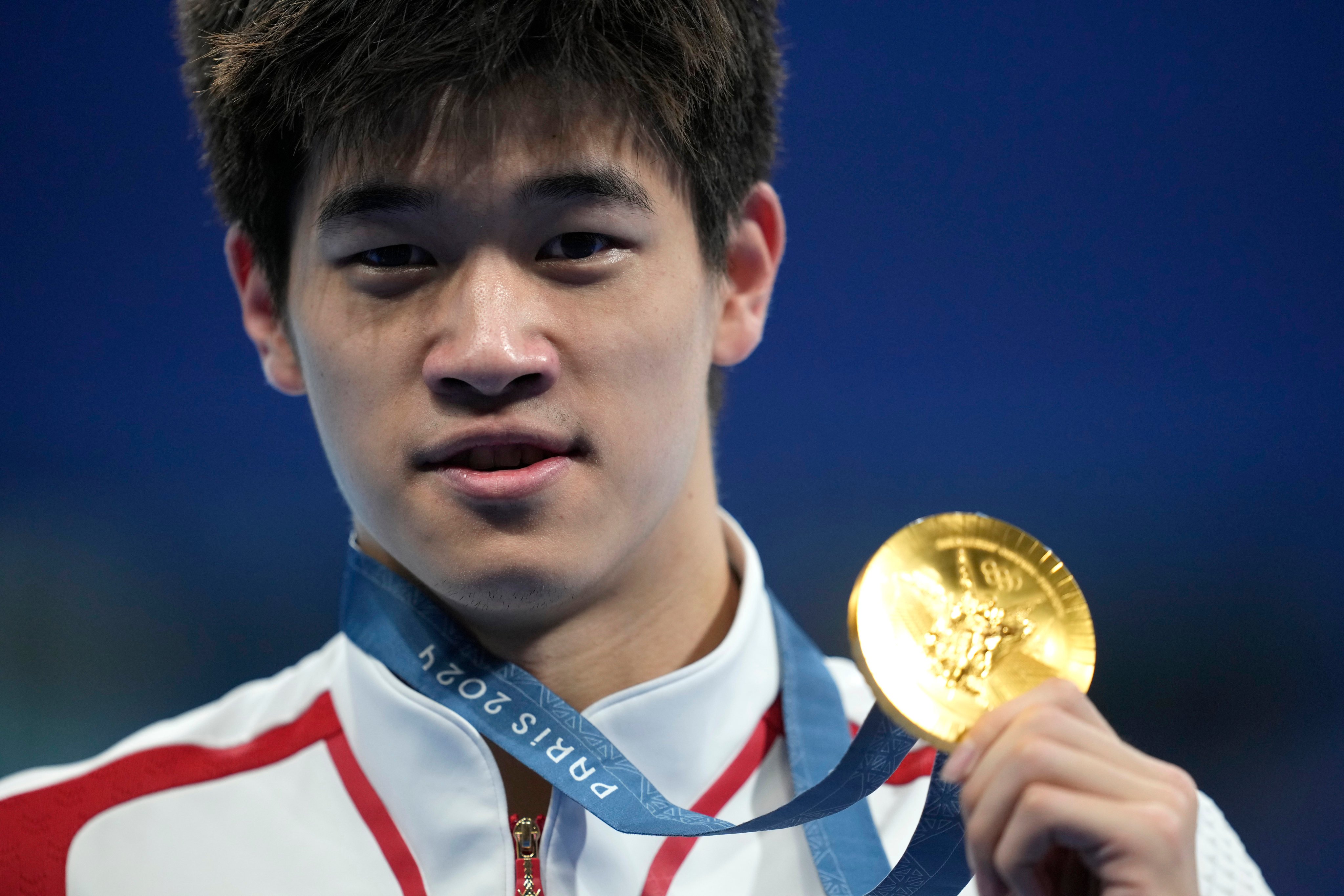 Chinese swimmer Pan Zhanle poses with his gold medal after winning the men’s 100 metre freestyle final at the Paris Olympics. Photo: AP