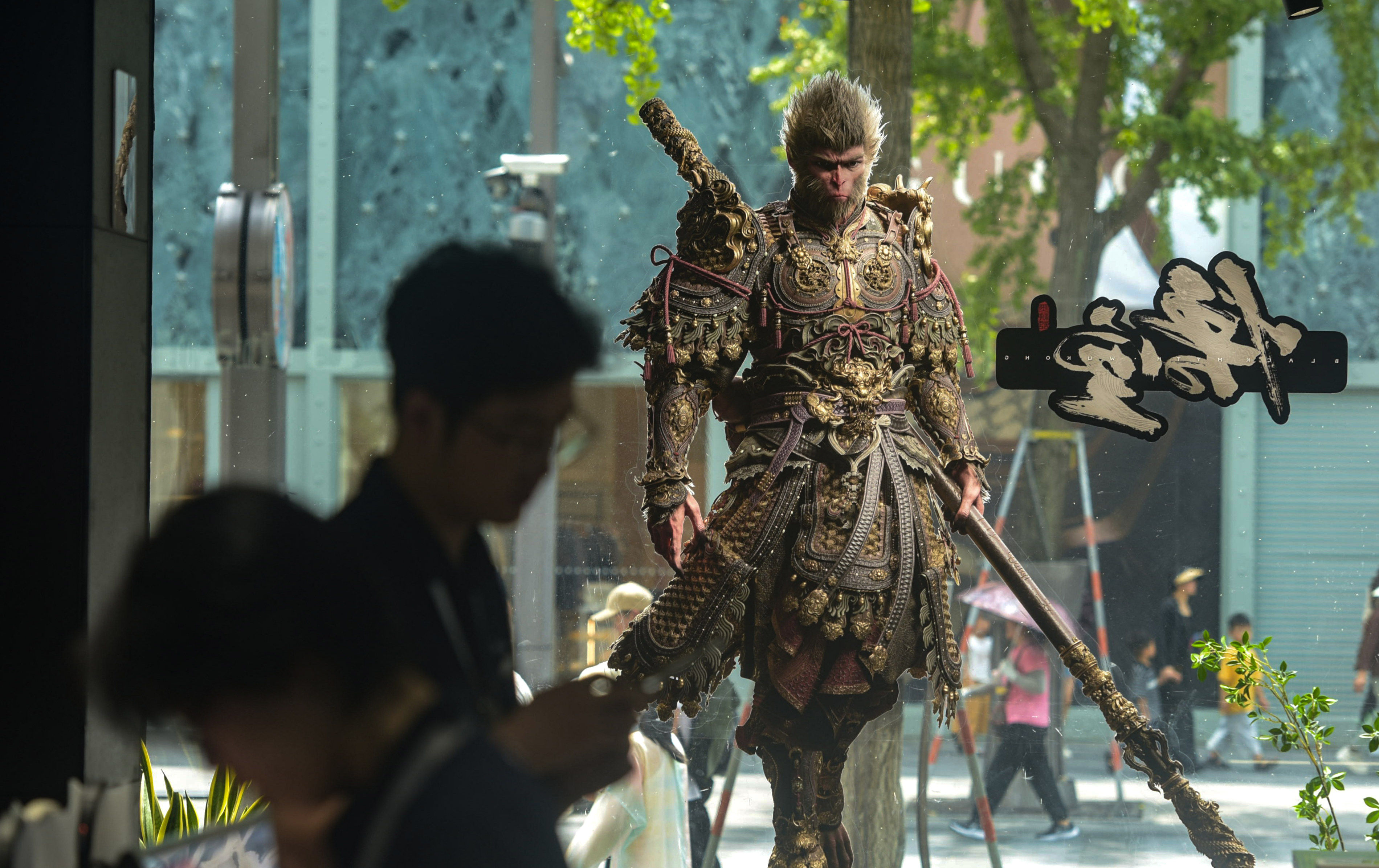 People walk past a poster for the video game “Black Myth: Wukong” in Beijing on August 21. Photo: Xinhua