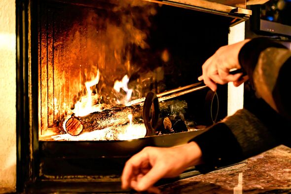 Log of wood burning in a fireplace inside a house, hearth