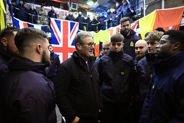 Keir Starmer talks to people with flags