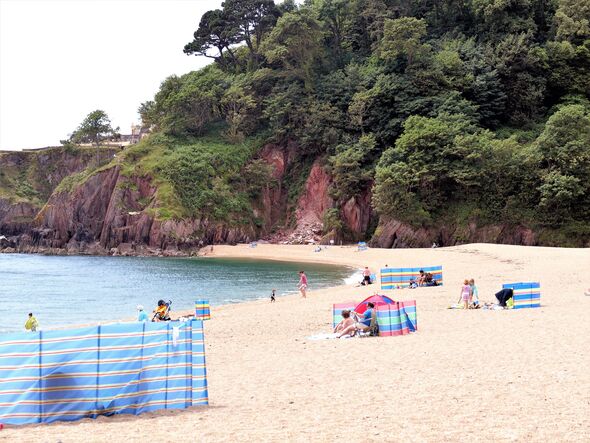 Sunbathers on Blackpool Sands, Devon, UK.