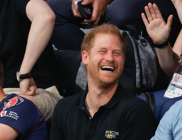 Prince Harry laughing in Invictus crowd.