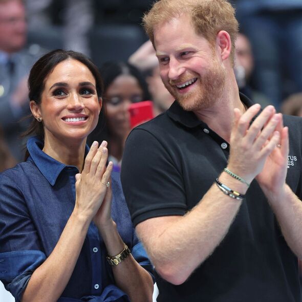 Prince Harry and Meghan Markle clapping