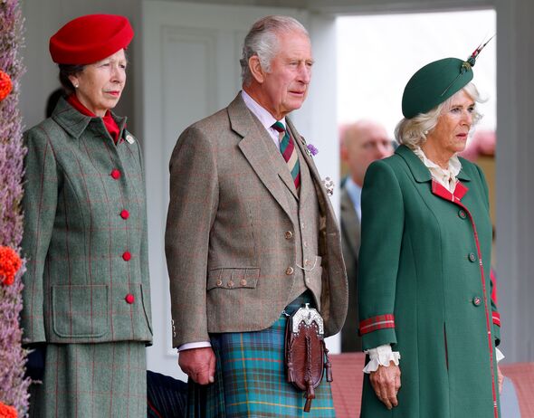 Princess Anne standing next to King Charles and Queen Camilla