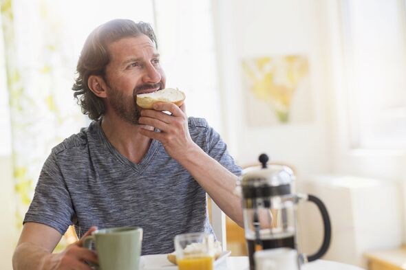 Mature man eating breakfast