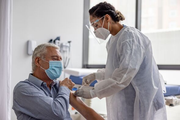 Adult man getting the COVID-19 vaccine at the hospital