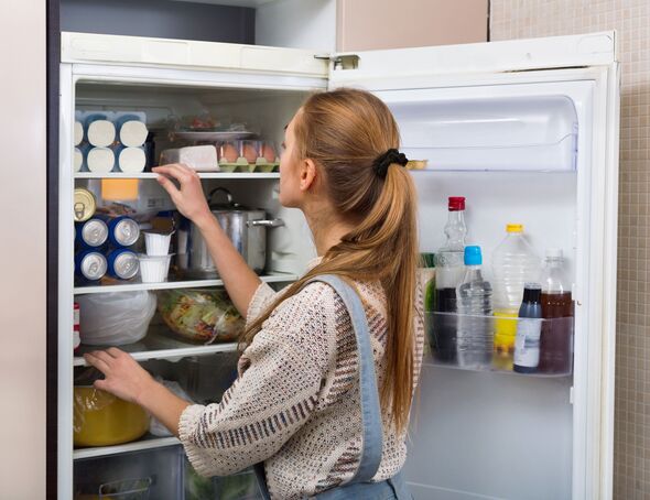 Woman looking in fridge