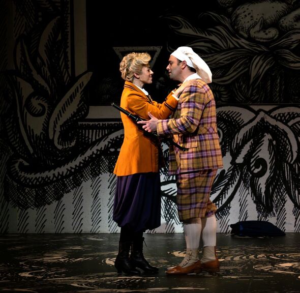 Lauren Snouffer as Pamina embracing Paul Appleby as Tamino, with his magic flute