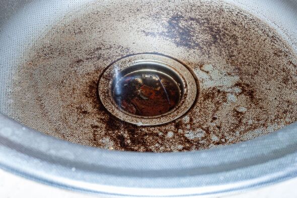 Clogged stainless steel sink plug hole close up