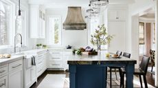 kitchen with white cabinets and blue island