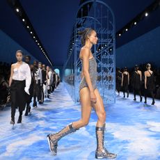 Dior Spring/Summer 2025 models walk down the runway in the finale, wearing glittering swimsuits, white shirts and black trousers