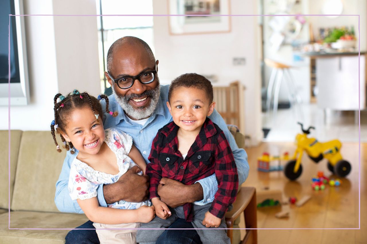 Grandparent holding grandson and granddaughter