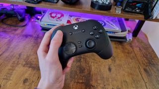 The Razer Wolverine V3 Pro being held by a reviewer