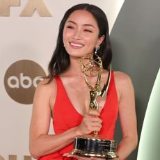 anna sawai in red with her emmy award 