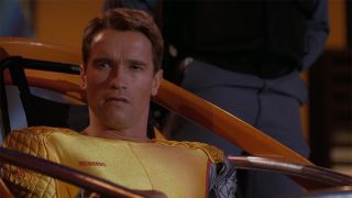 arnold schwarzenegger as ben richards loaded into a shuttle in the running man 