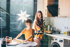 A mother and son baking cookies together