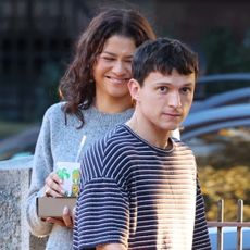 Zendaya and Tom Holland walking in Boston wearing a Reformation sweater