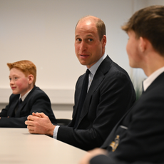 Britain's Prince William, Prince of Wales (C) speaks with students of the Matrix Project, including twelve-year-old Freddie Hadley (L), who made the initial invitation to visit the school