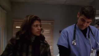 Eva Mendes standing next to George Clooney in ER