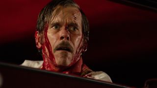 Kevin Bacon covered in blood and about to die in a car in MaXXXine