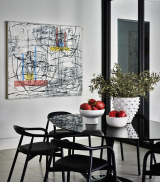 All white dining room with bold artwork