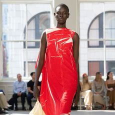 a model walks the spring 2025 Proenza Schouler and Ferragamo runways wearing the legging layering trend