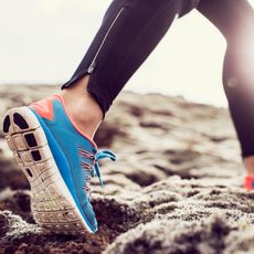 blue pair of running sneakers during a run