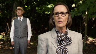 Susan Blommaert as Mr. Kaplan standing in a field on The Blacklist