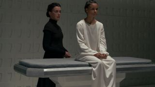 Olivia Williams stands behind Chloe Lea as she sits on a medical table in Dune: Prophecy S1 E2 - "Two Wolves."