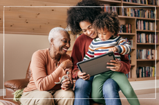 Three generations of family looking at tablet