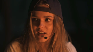 Maisy Stella with headpiece and backwards hat in One Less Lonely girl scene in My Old Ass