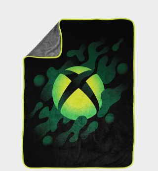 Xbox blanket with one corner folded over against a plain background