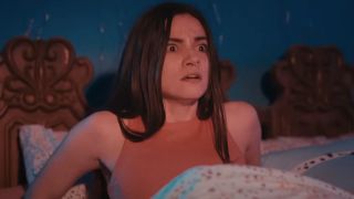 Lauren LaVera sits up in bed frightened in Terrifier 2.