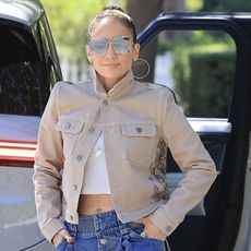 Jennifer Lopez wearing a beige jacket, wide jeans, and platform boots in Los Angeles August 2024