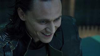 Loki smiling during Hulk's rampage in The Avengers