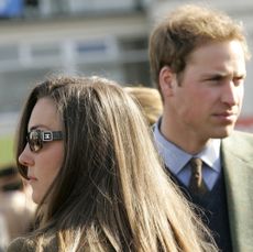 Kate Middleton wearing sunglasses looking to the side while Prince William turns to the other side behind her