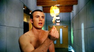 A shirtless Johnny Storm (Chris Evans) conjures a flame in his hand in "Fantastic Four" (2005)